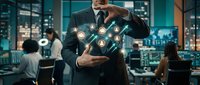 Professional businessman in suit presenting digital network icons in modern office environment with colleagues working in background.