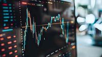 Financial market data displayed on dark screen with glowing blue candlestick chart showing stock price movements and trading analysis against blurred background.