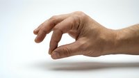 Adult male hand with medium skin tone gesturing pinch or small size measurement against white background, suitable for business, education, and instructional design projects.