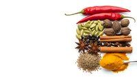 Colorful spices and herbs collection with red chili peppers, cardamom, nutmeg, star anise, cinnamon sticks, cumin and turmeric powder isolated on white.