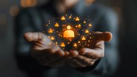 Glowing orange user profile icons floating above cupped hands against dark background, representing social network growth and customer relationship management.