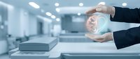 Businessman hands protecting glowing dollar symbol in modern office environment representing financial security and investment protection strategies.