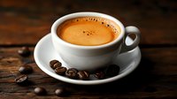 Fresh espresso coffee in white ceramic cup with saucer and roasted beans on rustic wooden table. Morning beverage with rich crema foam for cafe menu design.