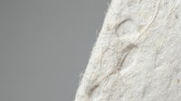 Soft beige knitted fabric with intricate cable pattern texture closeup on neutral background for cozy winter fashion and textile design projects.