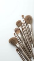 Professional makeup brush set with soft bristles and metallic handles arranged on a white background, perfect for beauty and cosmetics content.