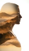 Double exposure silhouette of woman with misty mountain landscape at sunrise creating artistic blend of human profile and nature scenery.