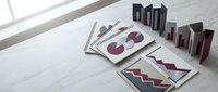Business analytics reports with colorful charts and graphs displayed on marble desk surface for corporate financial presentation and data analysis.
