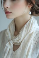 Young Caucasian woman in elegant white lace blouse with pearl earrings, soft natural lighting, fashion portrait for beauty and style concepts.