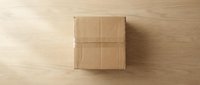 Closed cardboard box on wooden surface, top view for shipping, packaging, delivery, and logistics design projects.