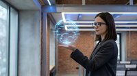 Professional businesswoman with glasses interacting with holographic digital globe in modern office environment for technology presentations.