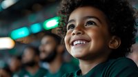 Young African American child with curly hair and bright smile looking up with wonder and joy against blurred background with green lights, expressing pure happiness.