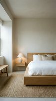 Modern minimalist bedroom with wooden bed frame, white bedding, neutral walls, natural light from window, cozy atmosphere for interior design projects.