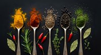 Colorful spices and herbs arranged on wooden spoons with fresh ingredients on dark background for culinary cooking and seasoning recipes.