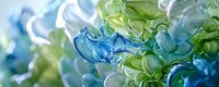 Abstract fluid art background with swirling blue and green translucent shapes creating dynamic motion effect, suitable for modern design projects and presentations.