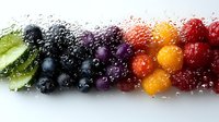 Fresh colorful berries and fruits with water drops arranged in rainbow gradient pattern on white background, macro photography showing vibrant natural colors.