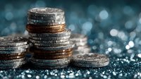 Stacked coins with sparkling bokeh lights creating wealth and financial success concept for investment and savings growth backgrounds.