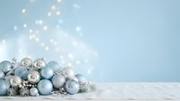 Assorted silver and blue ornaments with snowflakes and decorative elements arranged on white surface against soft blue background with bokeh lights, suitable for holiday and seasonal marketing.