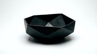 Matte black geometric faceted bowl with angular design on white background, isolated for modern interior, product, and design projects.