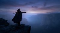 Woman with flowing dress standing on mountain cliff edge at dramatic purple sunset overlooking misty valley canyon landscape for freedom and adventure concepts.
