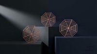 Three elegant copper wire geometric spider web sculptures displayed on modern pedestals with dramatic lighting for contemporary home decor and artistic design.