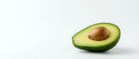 Halved avocado with pit isolated on white background, ready for culinary, nutrition, and healthy eating design projects.