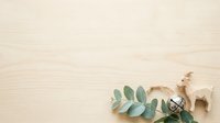 Flat lay composition with eucalyptus leaves, decorative llama figurine, and vintage keys on light wooden surface for design projects.