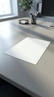 Blank white paper sheet on modern office desk with blurred workspace background for business presentations and document templates.