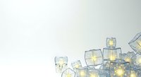 Isolated glowing ice cubes with warm yellow lights inside on white background, ready for design use on promotional materials, beverages, and digital graphics.