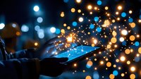 Magical glowing sparkles and light orbs floating from smartphone screen in dark, creating ethereal bokeh effect with blue and golden illumination. Night atmosphere.