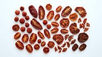 Assorted dried dates and nuts collection arranged on white background, healthy snacking ingredients for cooking and baking recipes.