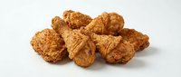 Crispy fried chicken pieces isolated on white background, ready for food packaging, restaurant menus, and culinary design projects.