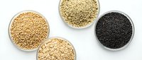 Variety of healthy seeds and grains in white bowls on clean background for cooking, nutrition and wellness concepts.