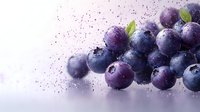 Fresh blueberries with water droplets and purple powder splash on white background for healthy food and nutrition concepts.