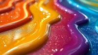 Vibrant waves of colorful paint create abstract flowing lines with glossy texture and sparkle effect, macro photography showing detailed liquid surface patterns.