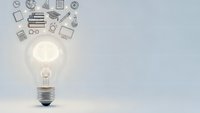Glowing light bulb with educational icons floating above on clean background representing creativity, innovation and learning concepts for business presentations.