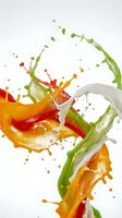 Colorful liquid splash with green orange red and white paint drops isolated on white background for creative design projects and artistic concepts.