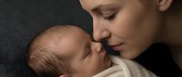 Tender moment between loving mother and newborn baby in intimate bonding embrace. Peaceful maternal connection showcasing early parenthood and family love.