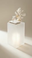 Minimalist white acrylic display pedestal with dried flowers, perfume bottle and books creating elegant neutral aesthetic for modern interior design.