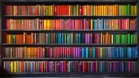 Colorful books arranged in rainbow spectrum order on dark wooden library shelves create striking visual display perfect for education, learning and knowledge concepts.
