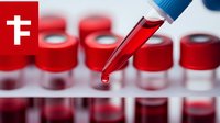 Medical dropper with blood sample over collection tubes in laboratory setting, red liquid dropping into vial for clinical testing and analysis.
