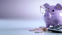 Purple piggy bank wearing glasses with coins and calculator for financial planning and savings management concepts.