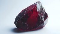 Raw uncut deep red ruby crystal mineral specimen on white background, showing natural crystalline structure and translucent properties for jewelry or gemology use.