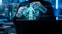 Businessman hands protecting glowing human hologram with digital interface in modern office environment representing healthcare technology and data security.