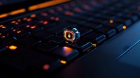Illuminated gaming keyboard with glowing orange backlight and Q key in focus, creating moody atmosphere for gaming and technology concepts.
