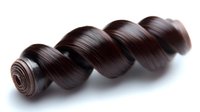 Dark brown loose wave hair extension weft showing spiral curl pattern on white background, isolated for beauty and fashion industry use.