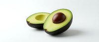 Fresh avocado halves with pit isolated on white background, ready for food and nutrition design projects, healthy eating concepts, and culinary applications.