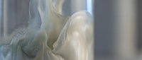 Translucent white fabric flowing with soft folds and gentle movement, creating an ethereal effect with light passing through delicate material for textile and design projects.