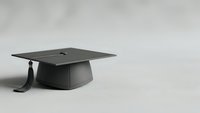 Black graduation cap with tassel on neutral background symbolizing academic achievement and educational success for ceremony celebrations.