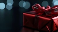 Red wrapped gift box with satin bow against dark background with soft bokeh lights creating festive holiday atmosphere. Elegant present for special occasion.