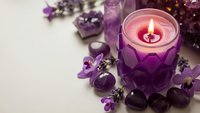 Purple candle burning in decorative holder surrounded by amethyst crystals and gemstones creating peaceful meditation and wellness atmosphere.